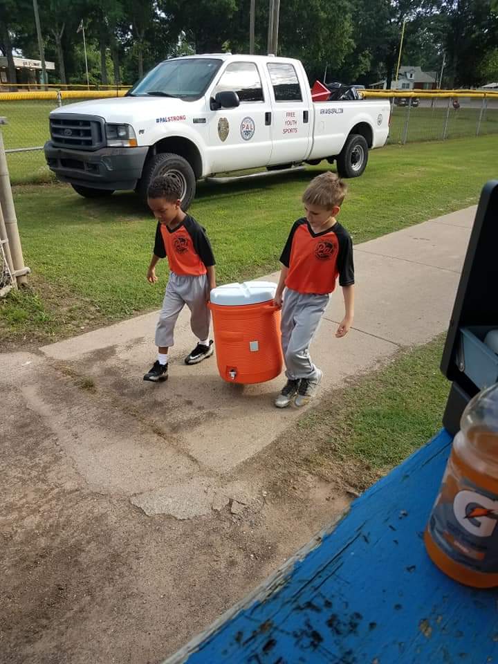 Baseball players carrying a jug