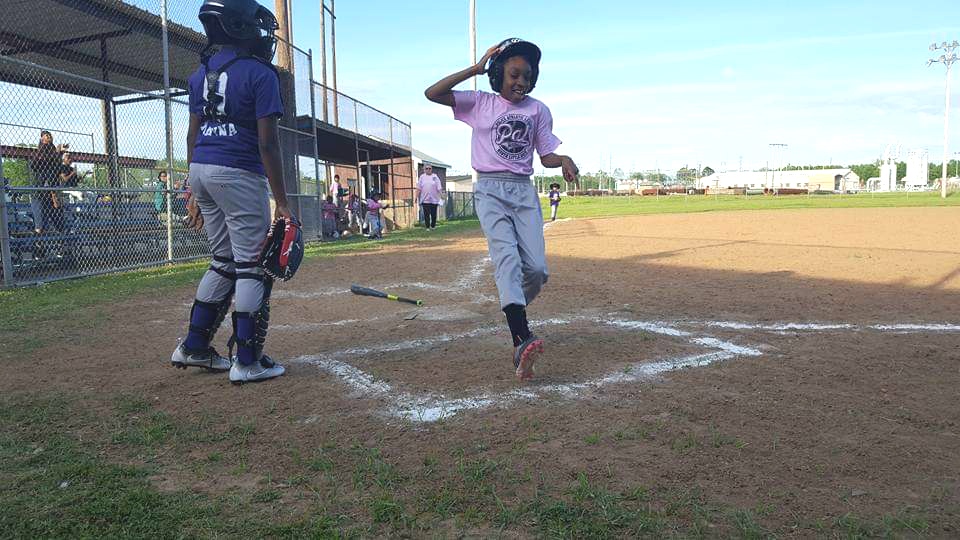 Young softball player reaches home base 